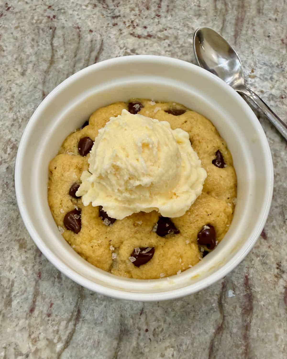 A single serve chocolate chip cookie in a ramekin. 