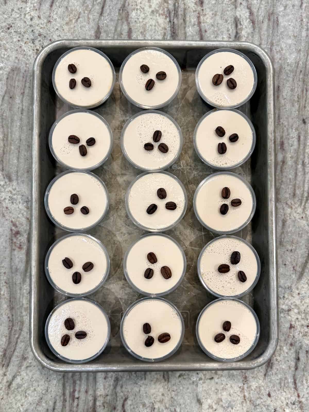 A baking sheet filled with 15 espresso martini Jell-O shots.
