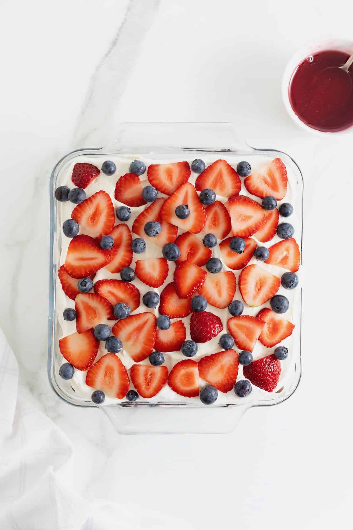 Fresh blueberries and strawberries on an ice cream sandwich cake.