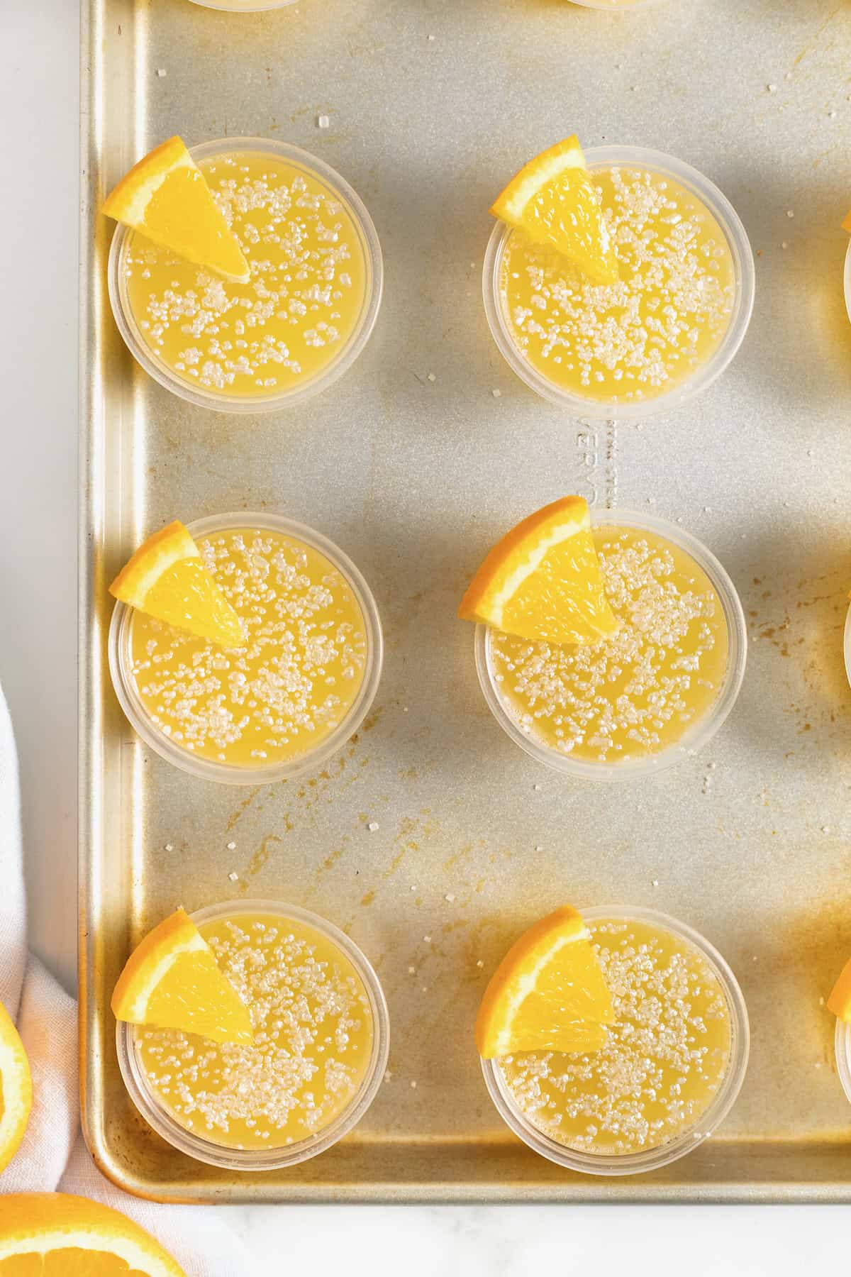 Mimosa jello shots on an aluminum baking sheet.