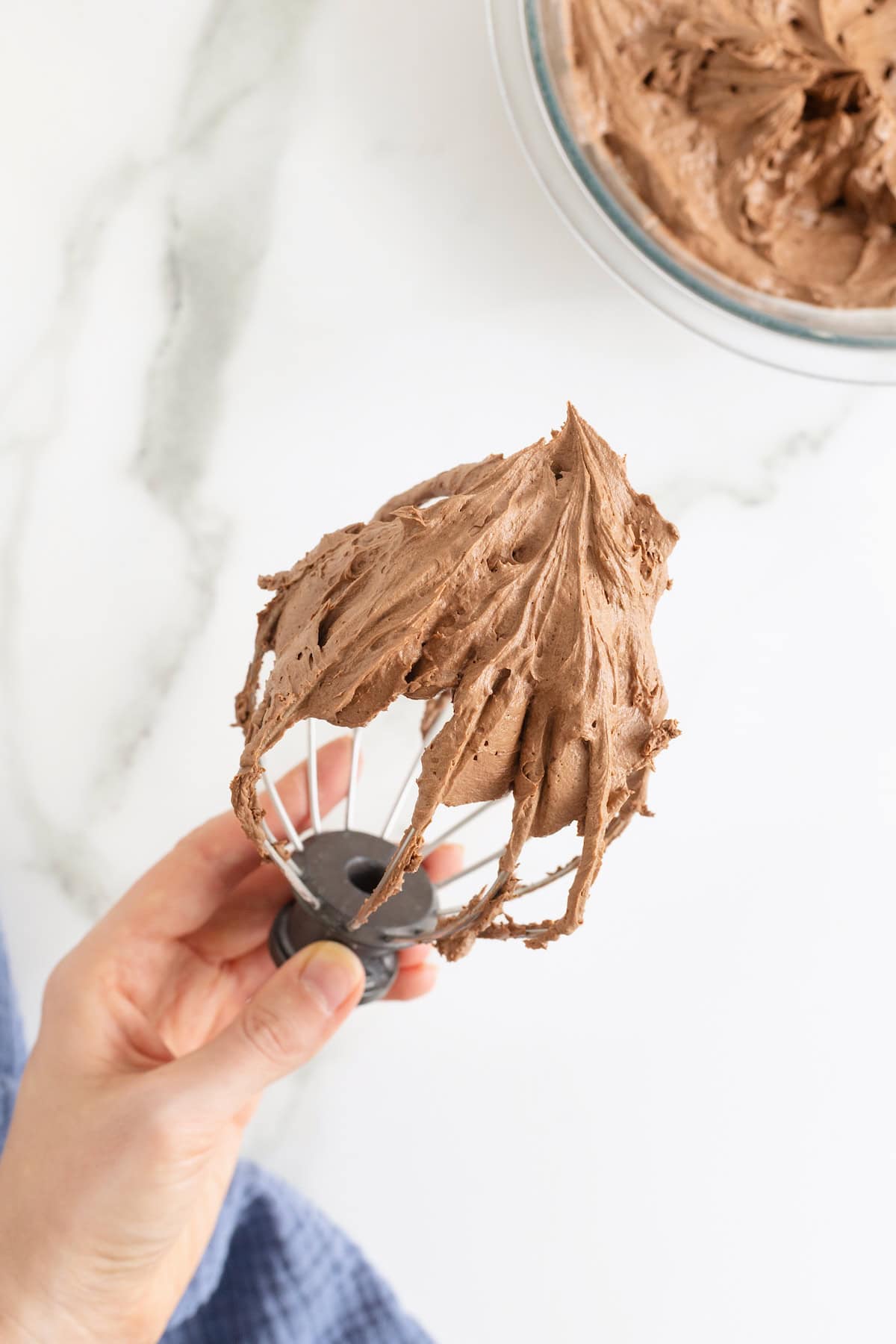 Chocolate frosting on a wire whisk.