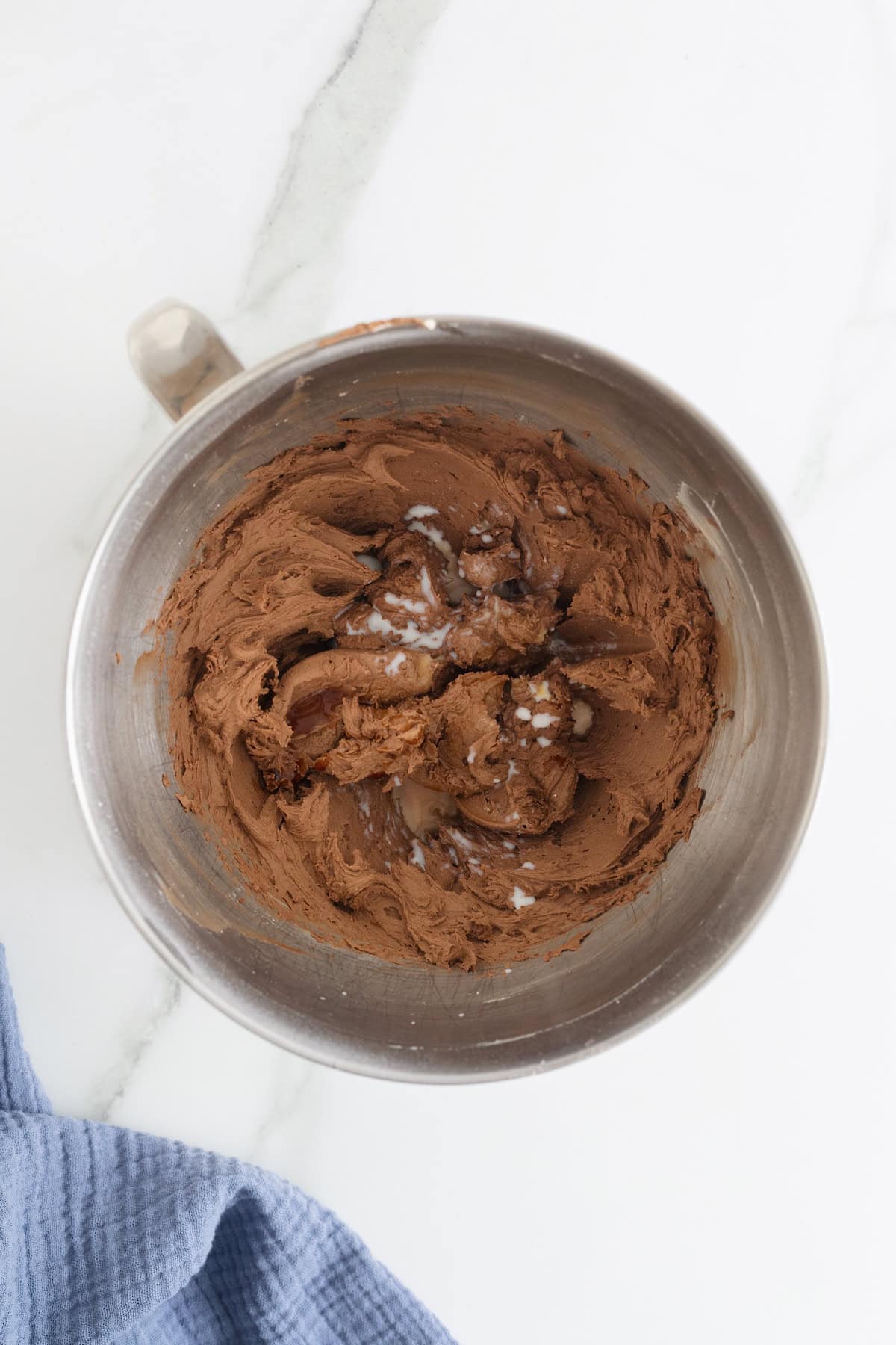Vanilla and milk added to chocolate buttercream frosting.