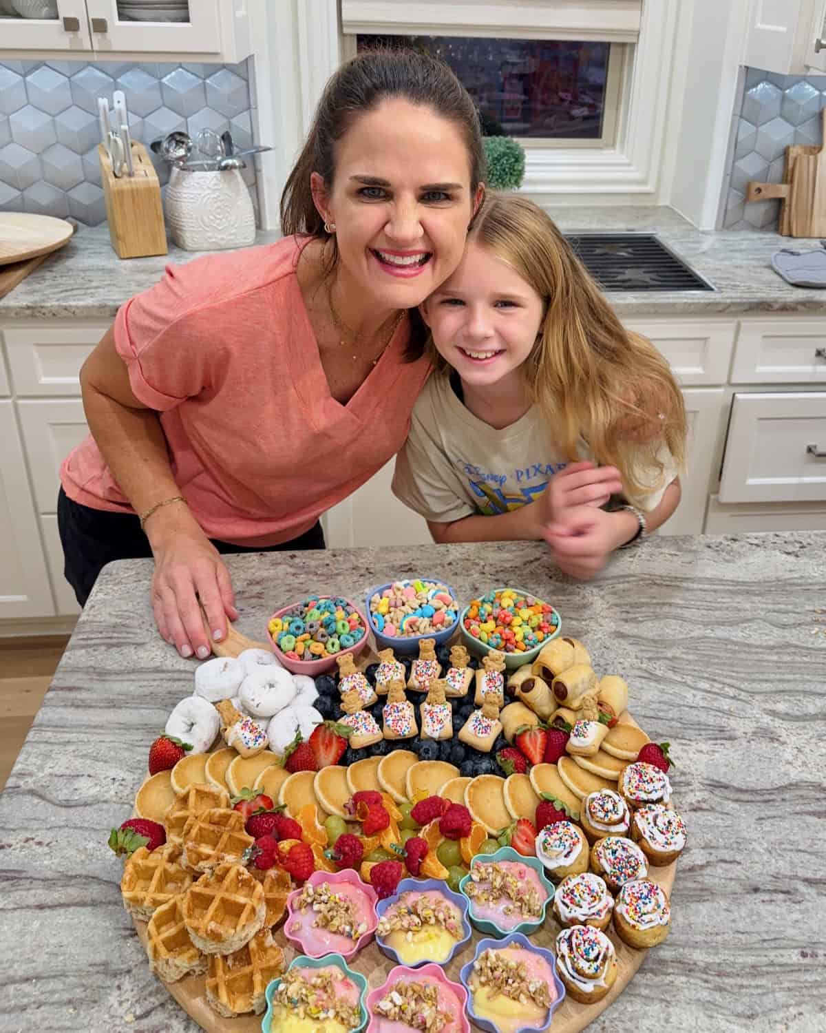 Maegan Brown and Brookie Brown posing in front of a dessert board.