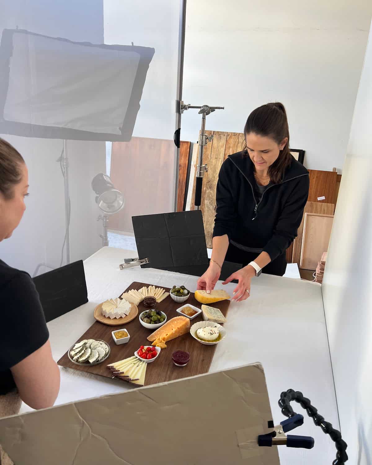 Maegan placing cheese on her Epic Grazing Board.