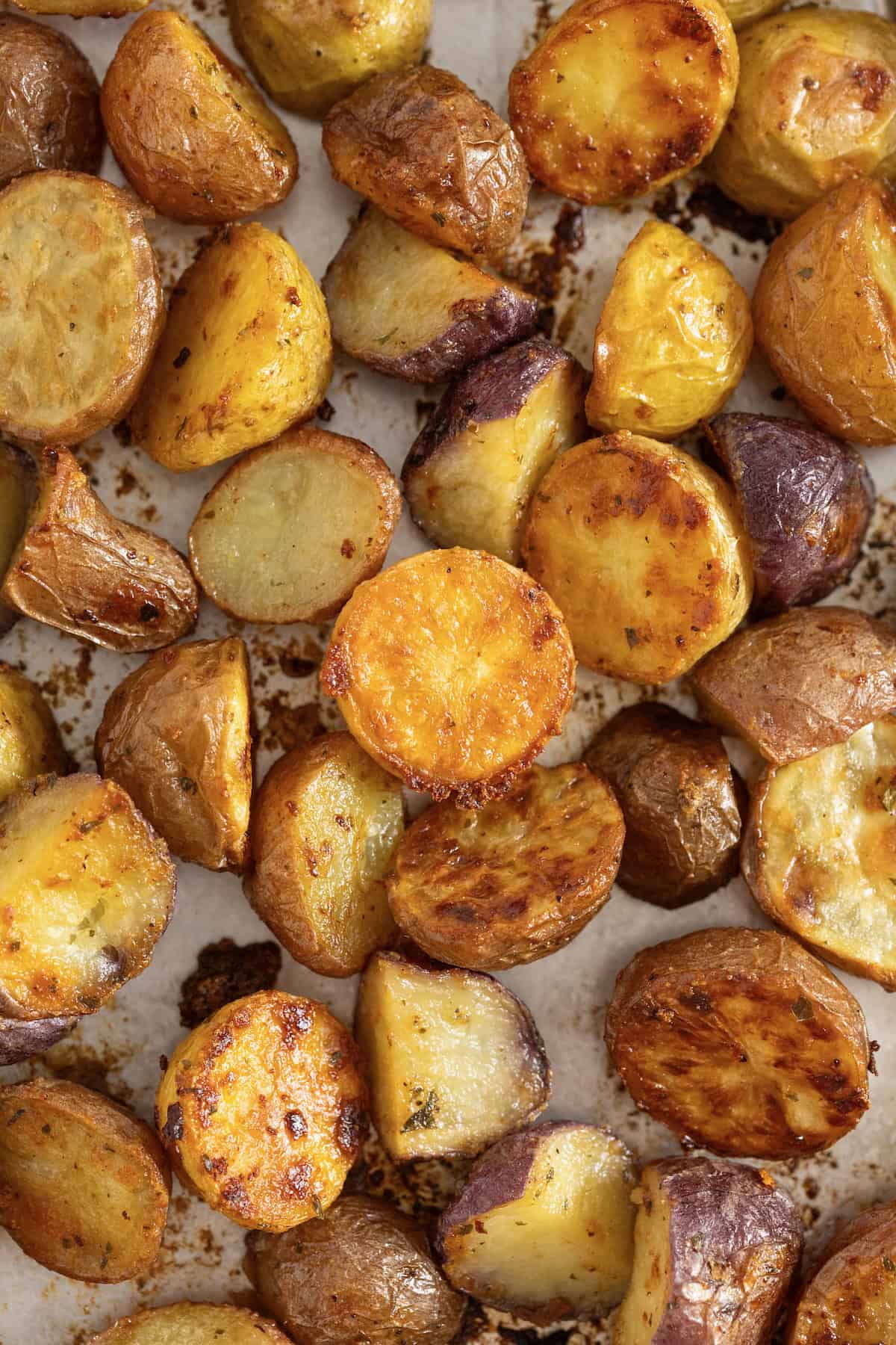 Crispy ranch potatoes on an aluminum baking sheet.