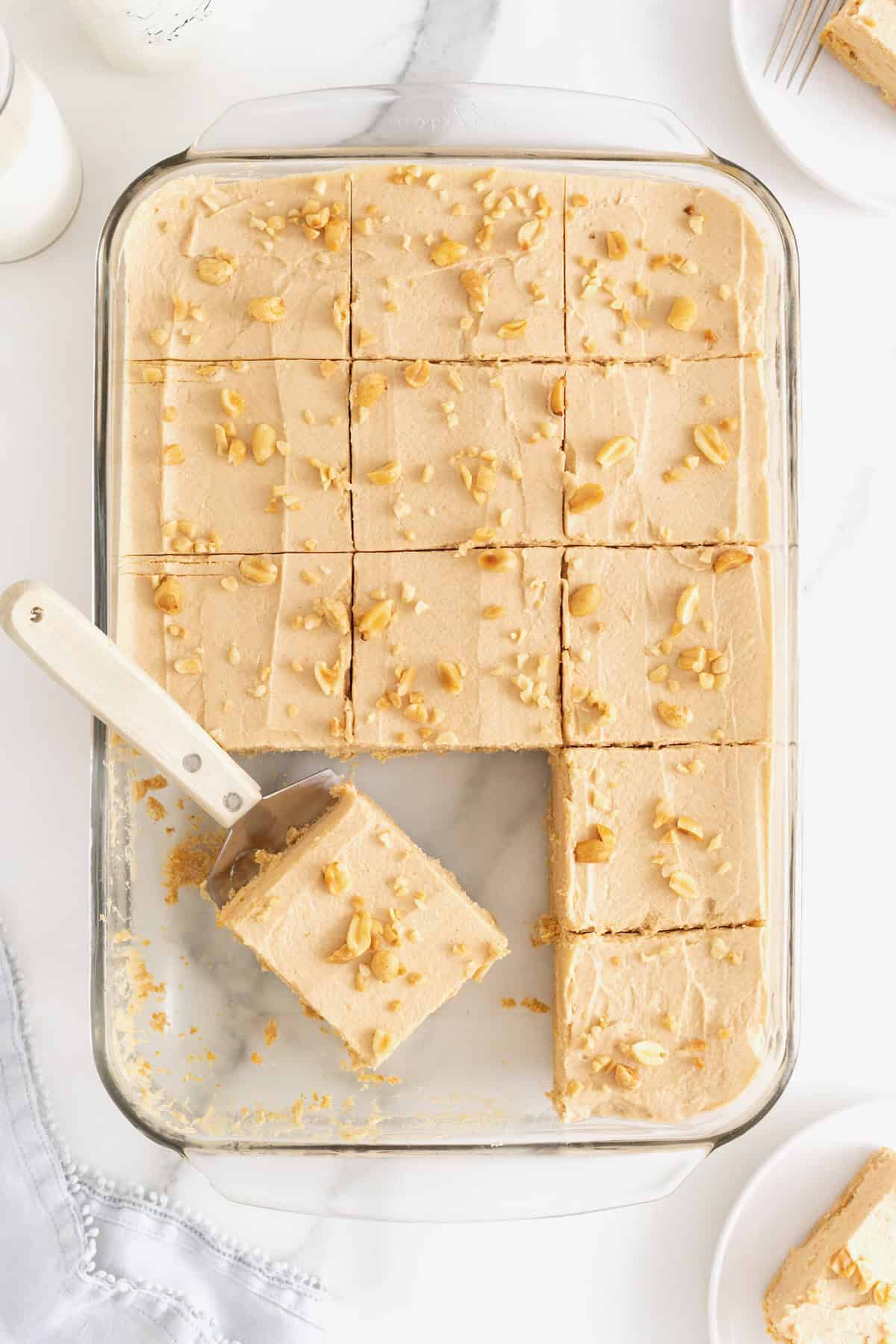 A glass dish of no-bake peanut butter pie bars.
