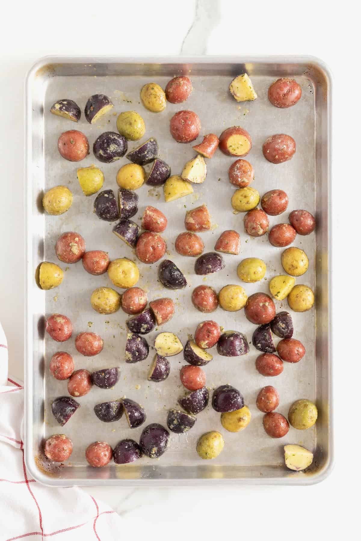 Crispy ranch potatoes on an aluminum baking sheet.